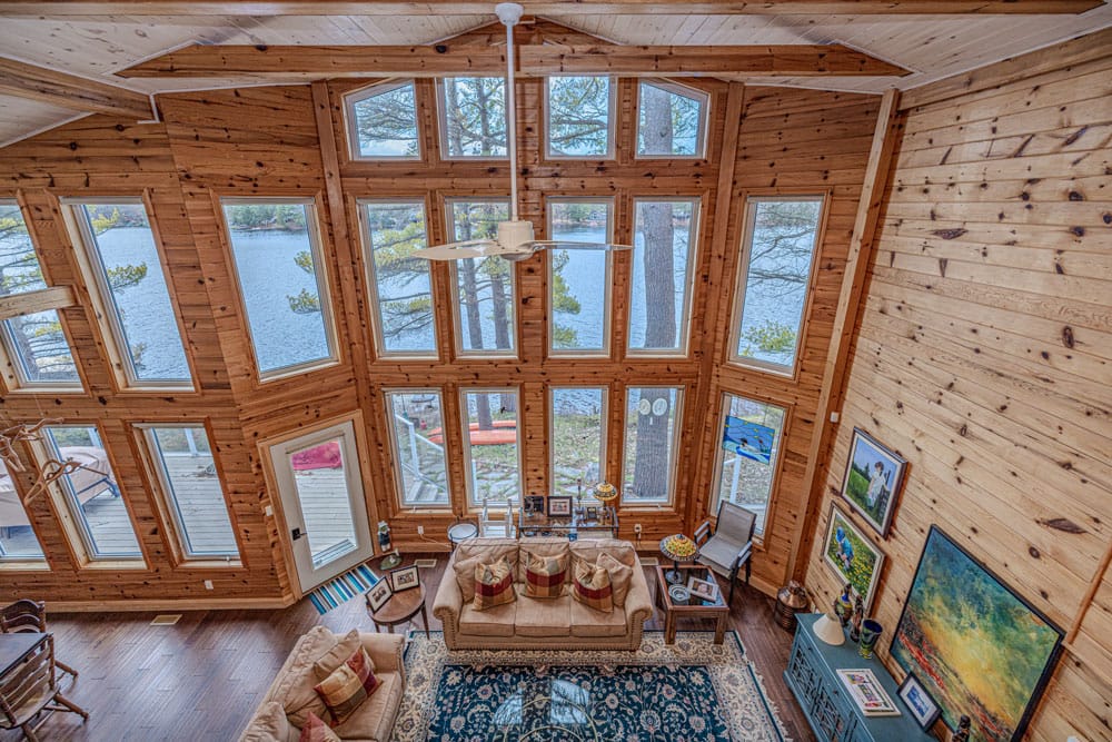 Fully restored interior of a Loon Lake cottage in Gravenhurst with repaired pine walls refinished hardwood floors and new window frames after complete ice dam damage restoration
