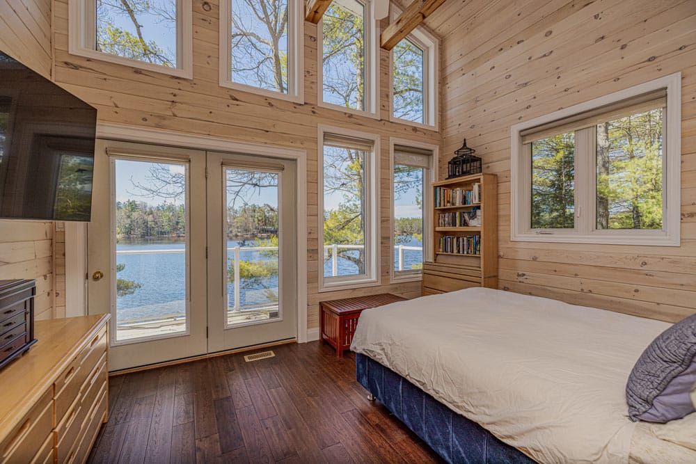 Restored tongue-and-groove pine wall cladding in a Gravenhurst cottage with replacement boards matched to the original grain colour and profile after ice dam damage repair