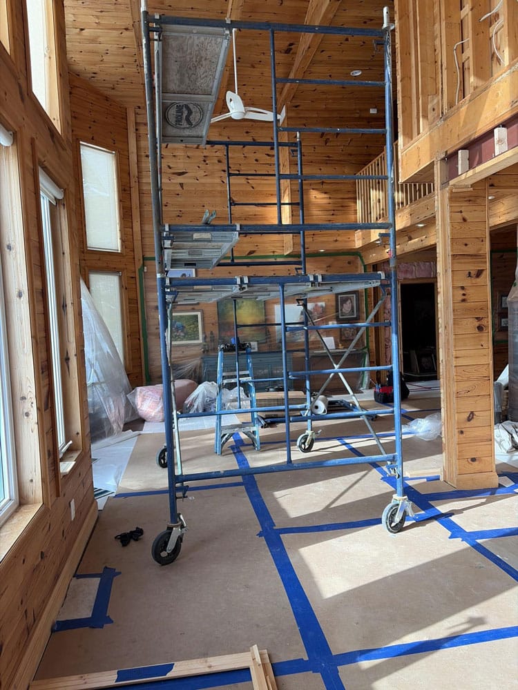 Water-stained tongue-and-groove pine wall cladding inside a Gravenhurst cottage caused by years of ice dam water infiltration through the roof assembly above