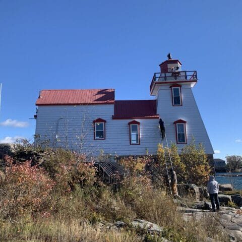 picture-1028459971 A full view of the site shows the rugged access conditions and the lighthouse’s commanding position over the water.